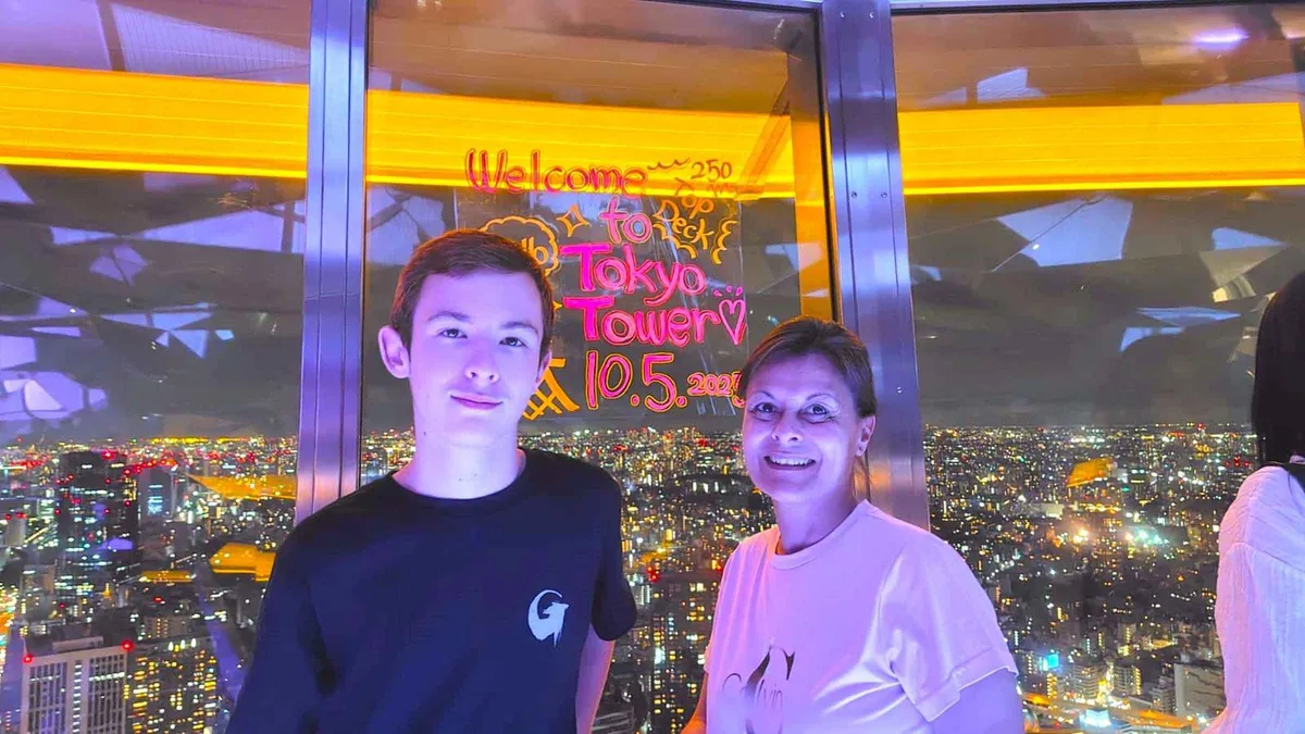 Small guided group taking in the Tokyo skyline from Tokyo Tower's Top Deck, guided Tokyo Tower tour